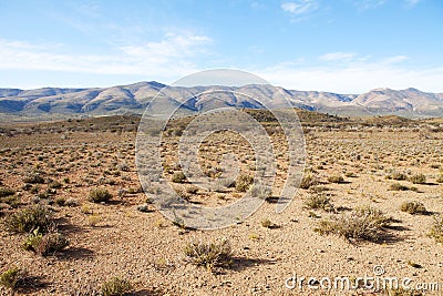 Semi-desert region with mountains and blue sky Stock Photo