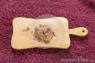 Red rice on a wooden board Stock Photo