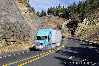 SEMI TRUCK DRIVING ON MOUNTAIN HIGHWAY Editorial Stock Photo