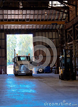 Semi truck entering old antic building warehouse unloading cargo Stock Photo