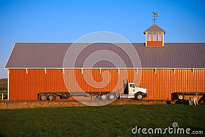 Semi truck flat bed trailer red horses barn stable Stock Photo