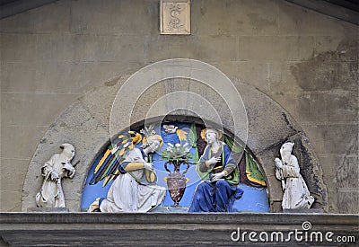 Semicircle containing a beautiful terracotta sculpture painted on the wall of a historic building in Florence. Stock Photo
