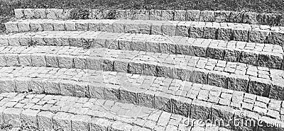 Semicircular steps of the amphitheater. Wide staircase made of stone blocks or bricks. Uneven bricks. The old steps are Stock Photo