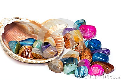 Semiprecious multicolored agate stones in stripe with seashell on white background, Stock Photo