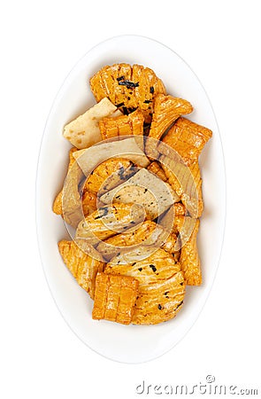 Senbei, Japanese rice crackers, crispy snacks, in a white oval bowl Stock Photo
