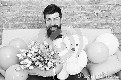 Send flowers like you mean it. Flower for March 8. Bearded man with tulip bouquet and bear. Love date. international Stock Photo