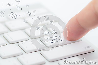 Sending email. gesture of finger pressing send button on a computer keyboard. Stock Photo