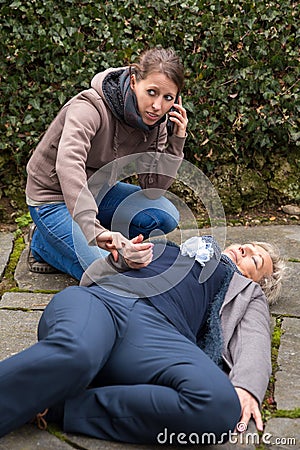 Senior adult is lying on the ground Stock Photo