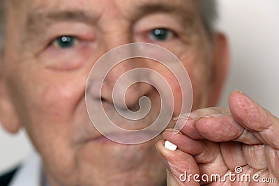 Senior adult with medicine pill Stock Photo