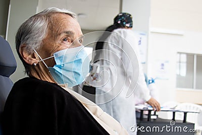 Senior adult under observation to monitor any adverse effects attributable to the vaccine after the application of the first dose Stock Photo