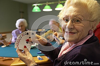 Senior adults playing bridge Stock Photo