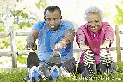 Senior African American Couple Exercising In Park Stock Photo