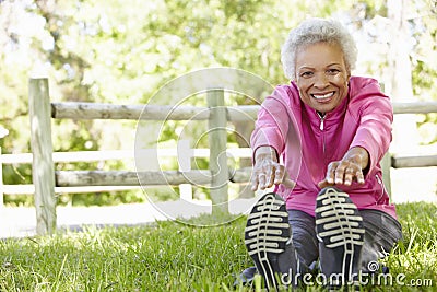 Senior African American Woman Exercising In Park Stock Photo