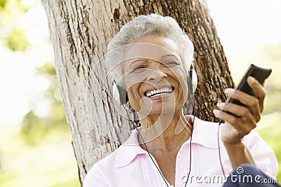 Senior African American Woman In Listening To MP3 Player Stock Photo