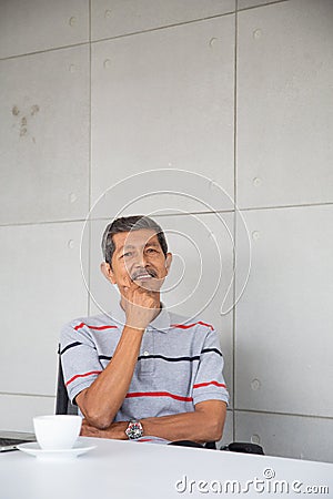 Senior Asia businessman sit and smile Stock Photo