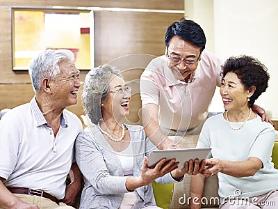 Senior asian couples using tablet computer Stock Photo