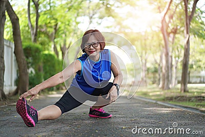 Senior asian woman stretch muscles at park Stock Photo