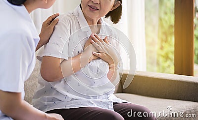 Senior asian woman having chest pain suffering from heart attack,Nurse take care and support Stock Photo