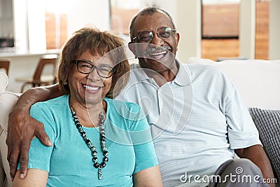 Senior African American couple sitting at home, smiling to camera, close up Stock Photo