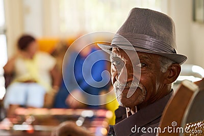 Senior Black Man With Hat Looking At Camera In Hospice Stock Photo