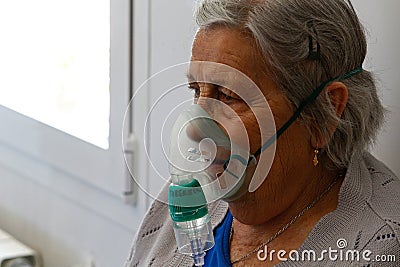 Senior wearing oxygen mask on a nursing home in Mallorca detail Editorial Stock Photo