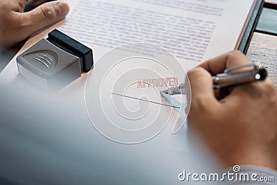 Senior business man male hand putting or signing signature in the certificate contract after approve stamp on loan document Stock Photo