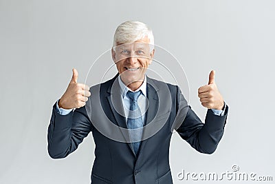 Business Lifestyle. Businessman standing isolated on gray thumbs up smiling positive Stock Photo