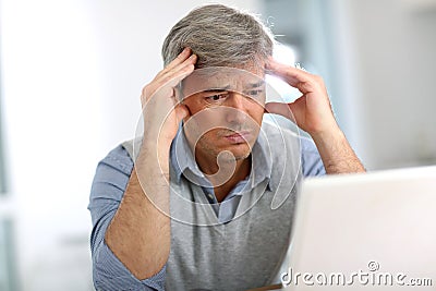 Senior businessman having a headache Stock Photo