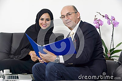 Senior Businessman working with Arabian Businesswoman wearing hijab Stock Photo