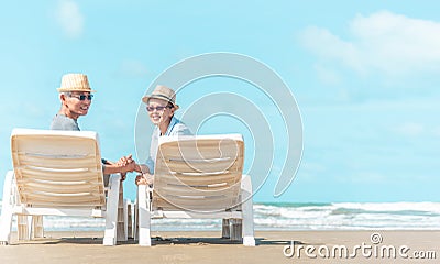 Senior caucasian couple sitting on bench near the sea and hugging. Horizontal shape, rear view, copy space Stock Photo