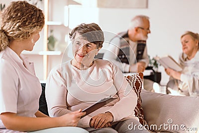 Senior caucasian woman talking with a nurse in the medical facility Stock Photo