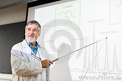 Senior chemistry professor giving a lecture in front of classroom Stock Photo
