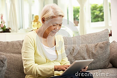 Senior Chinese Woman With Tablet Computer Stock Photo