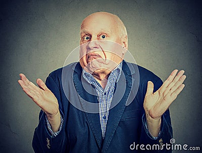 Senior confused man is shrugging his shoulders Stock Photo