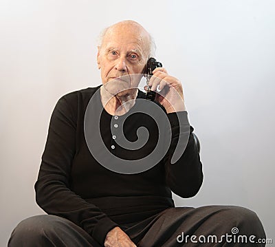 Senior on cordless phone Stock Photo