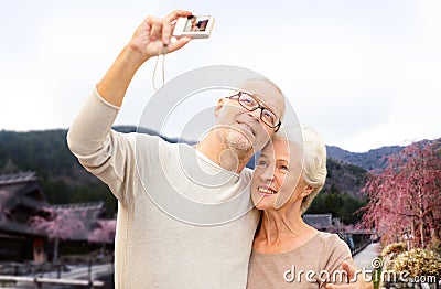 Senior couple with camera over asian village Stock Photo