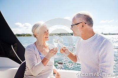 Senior couple clinking glasses on boat or yacht Stock Photo