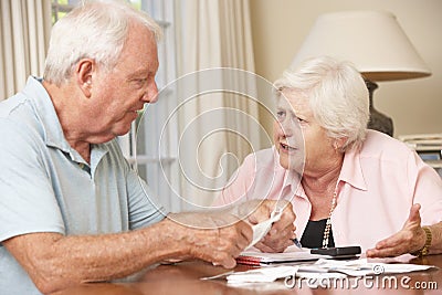 Senior Couple Concerned About Debt Going Through Bills Together Stock Photo