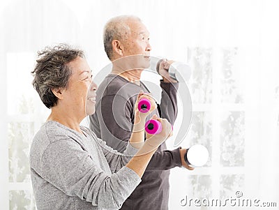 senior couple exercising with dumbbells Stock Photo