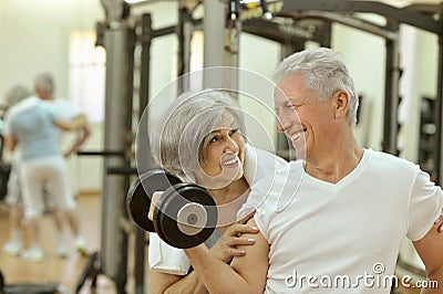 Senior couple exercising in gym Stock Photo