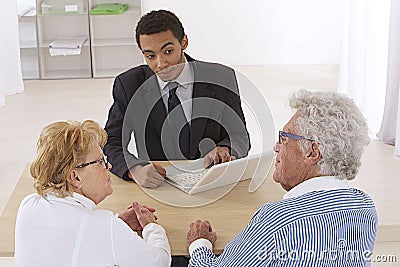 Senior couple with financial consultant Stock Photo