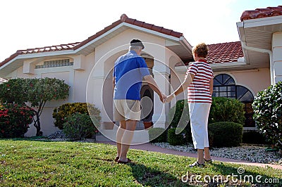 Senior couple in front of home Stock Photo