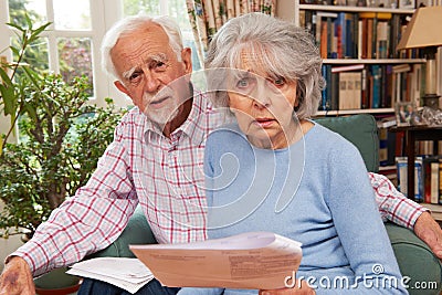 Senior Couple Going Through Finances Looking Worried Stock Photo