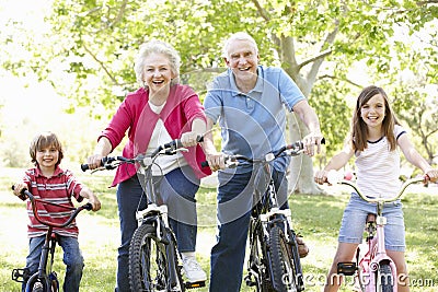 Senior couple with grandchildren on bikes Stock Photo