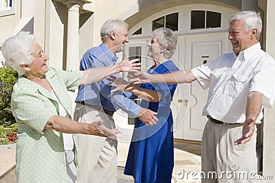 Senior couple greeting friends Stock Photo