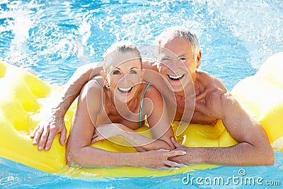 Senior couple having fun in pool Stock Photo