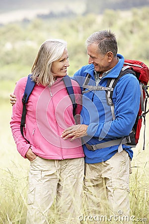 Senior Couple On Hike Through Beautiful Countryside Stock Photo