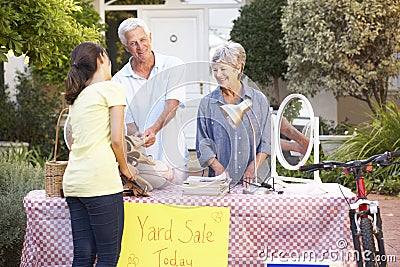 Senior Couple Holding Yard Sale Stock Photo