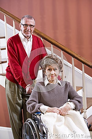 Senior couple at home, woman in wheelchair Stock Photo
