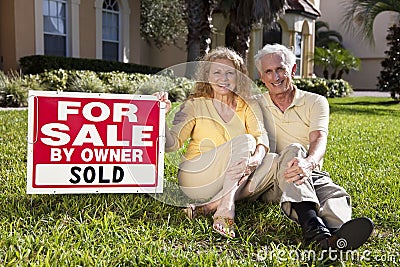 Senior Couple and House For Sale Sold Sign Stock Photo